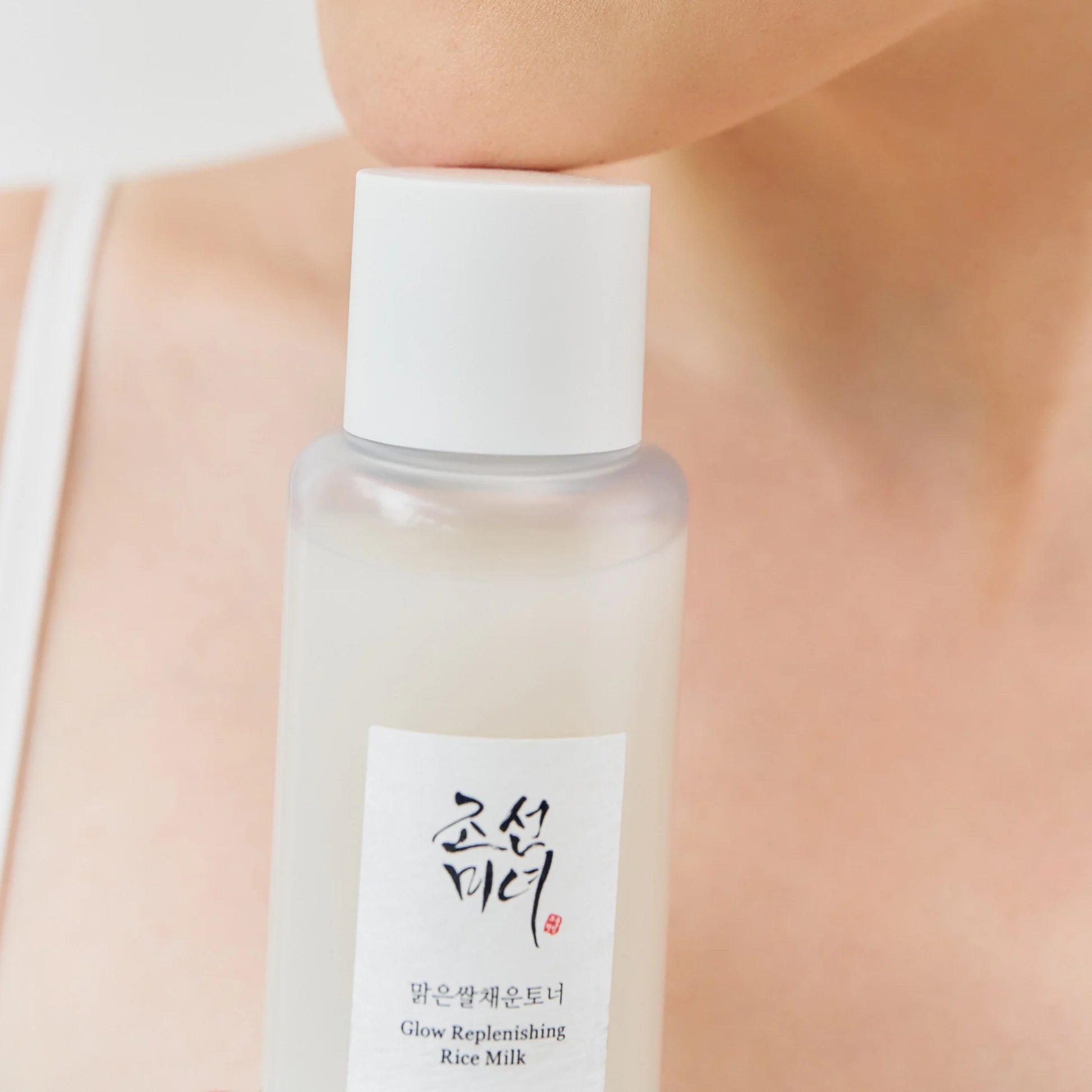 Beauty of Joseon Glow Replenishing Rice Milk 150ml bottle with white and gold label, skincare product on a neutral background.