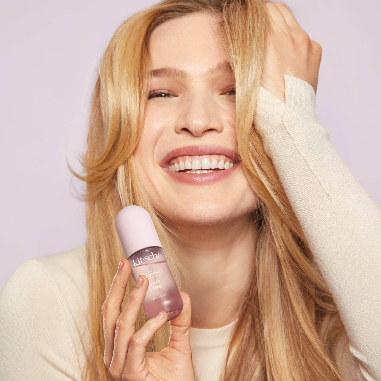 KITSCH Sheer Violet Hair Perfume bottle with purple floral design, showcasing elegant packaging and sprayer nozzle.