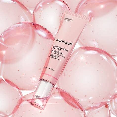 Medicube PDRN Pink Peptide Eye Cream in a 30ml jar, showing the skincare product with pink packaging and applicator.