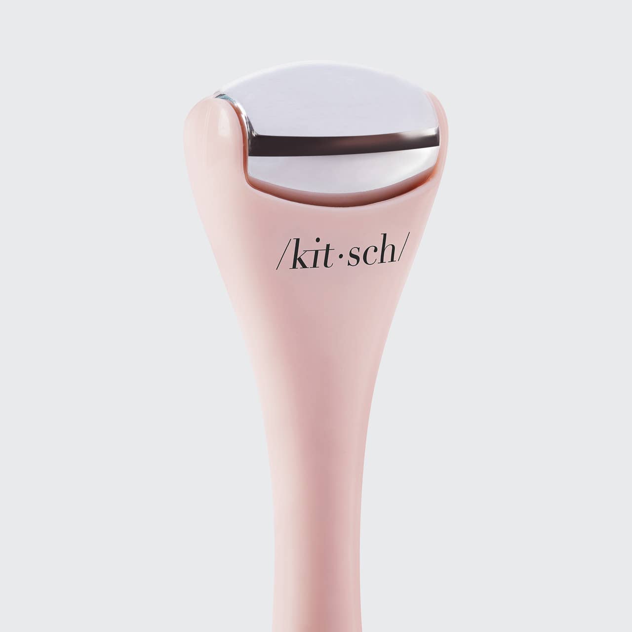 KITSCH Mini Spa Rollers 2-piece set for facial massage, made of smooth pink stone with textured surface for skin relaxation.