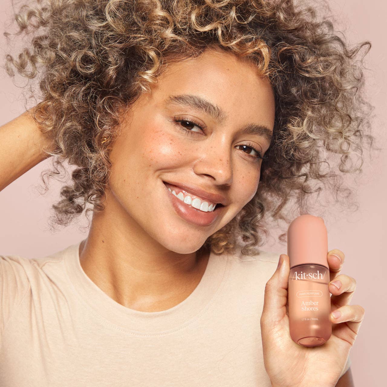 KITSCH Amber Shores Hair Perfume bottle with beige label and gold cap, designed for adding scent to hair.