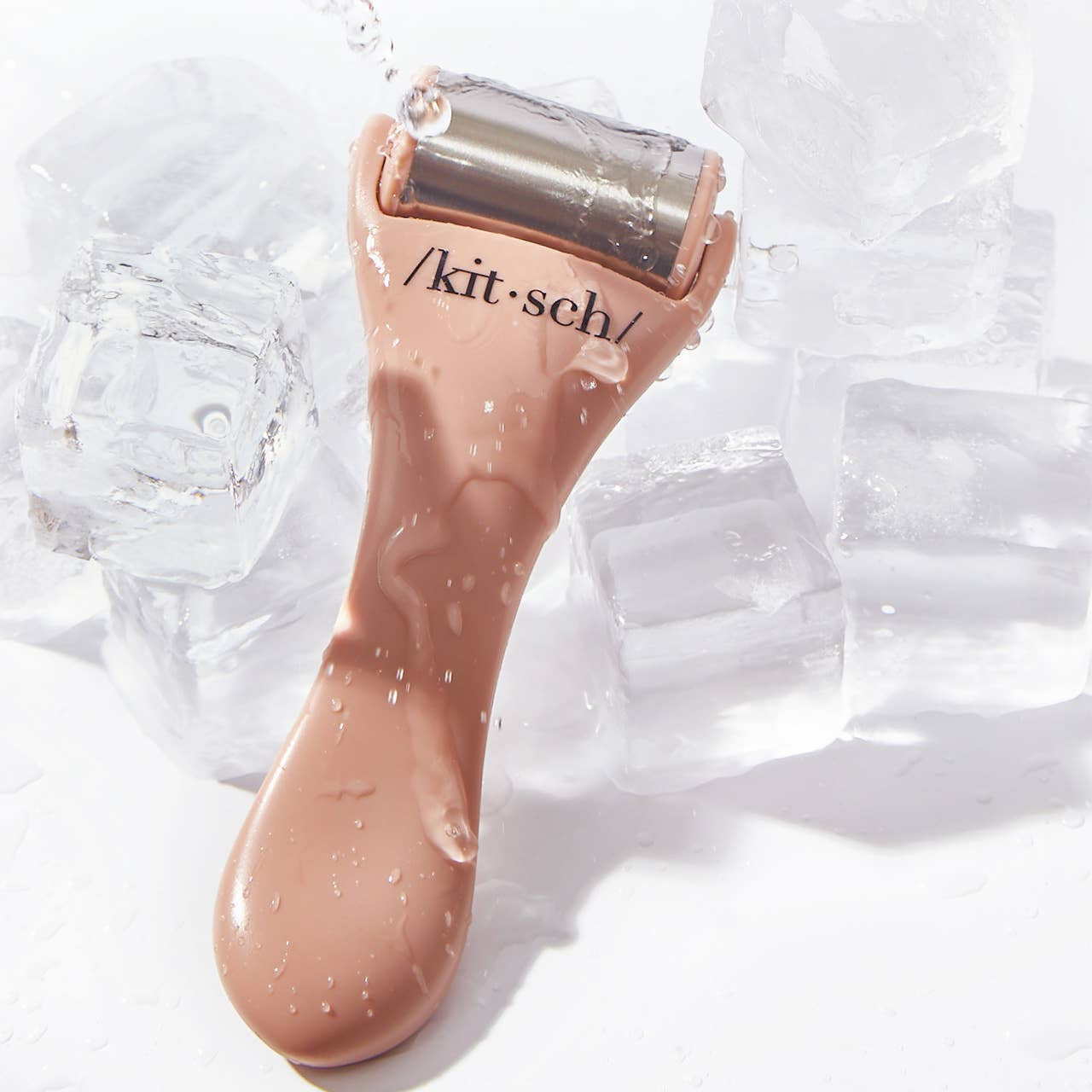 KITSCH Ice Roller in terracotta color, handheld skincare tool with a smooth roller for cooling and soothing skin.