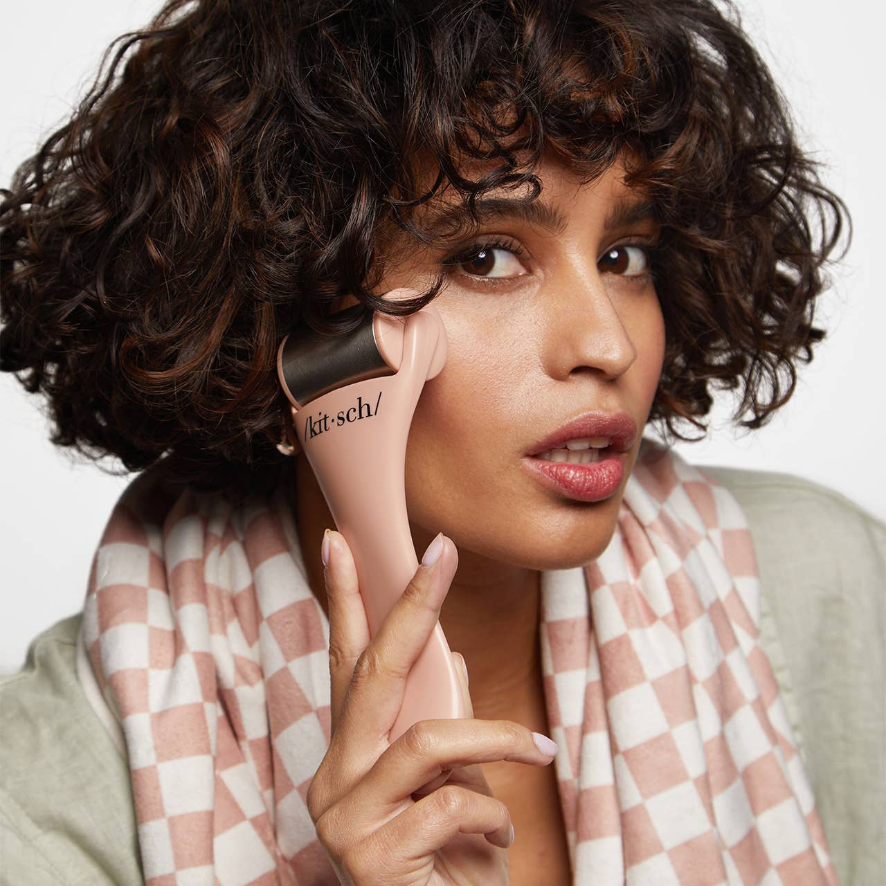 KITSCH Ice Roller in terracotta color, featuring a smooth, rounded surface for facial cooling and skincare routines.