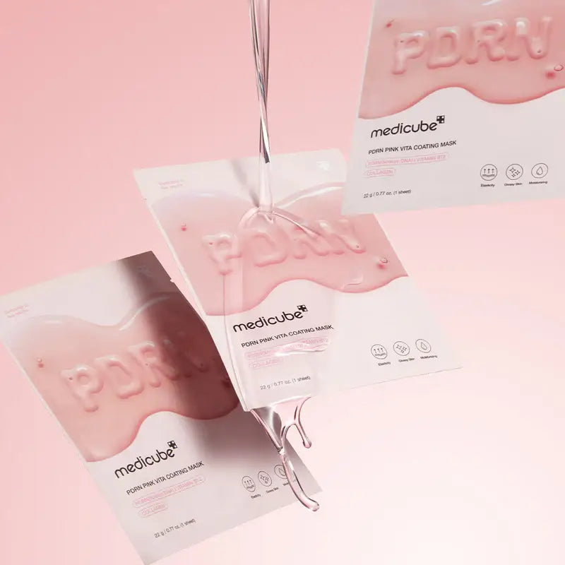 Medicube PDRN Pink Vita Coating Mask applied on a clean face, showcasing its pink-colored sheet mask for skincare and hydration.